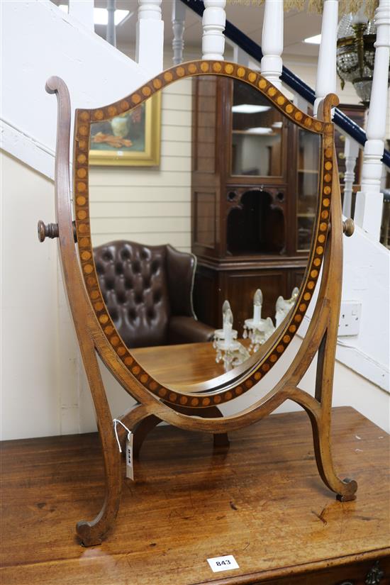 An Edwardian mahogany shield-shaped toilet mirror W.55cm.